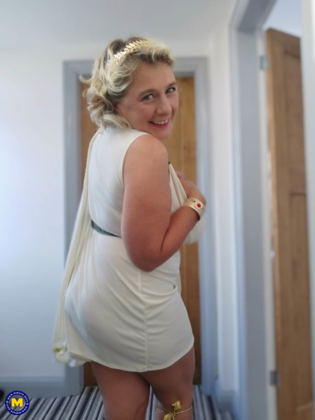 Blonde cougar with huge boobs Camilla C shows her bum in a solo