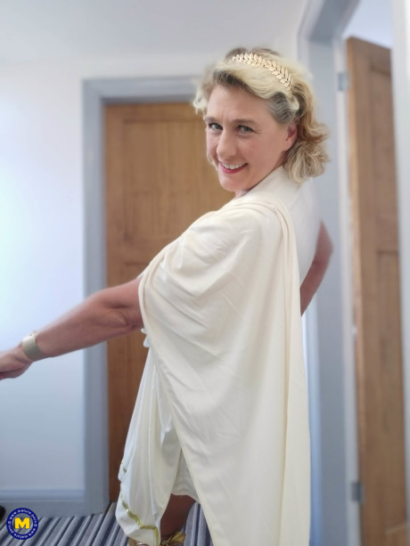 Blonde cougar with huge boobs Camilla C shows her bum in a solo