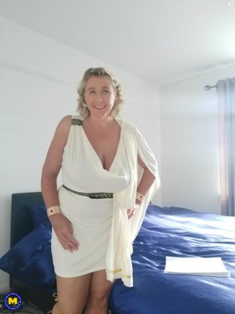 Blonde cougar with huge boobs Camilla C shows her bum in a solo