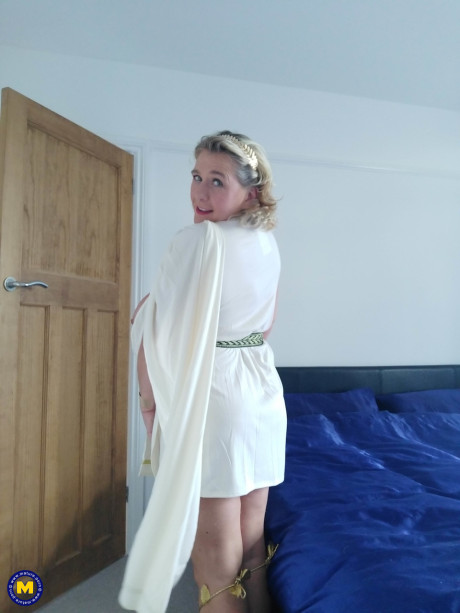 Blonde cougar with huge boobs Camilla C shows her bum in a solo