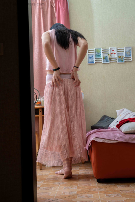 Tall brunette Elza flashing her tight behind & her humongous areolas while dressiing