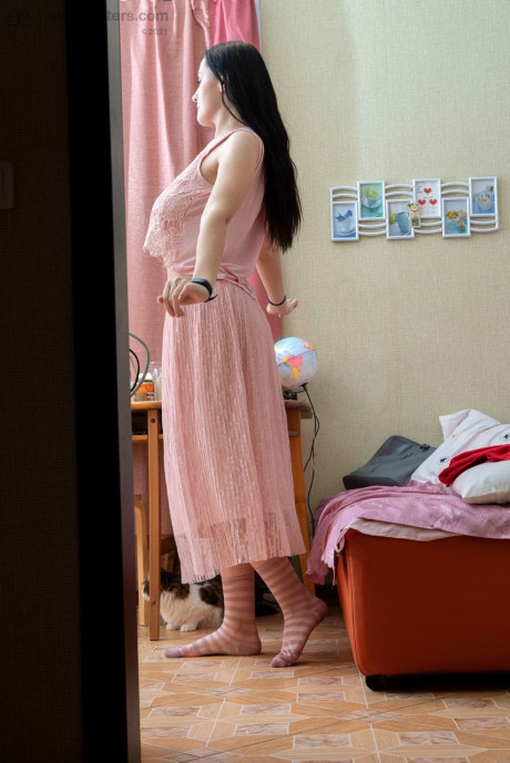 Tall brunette Elza flashing her tight behind & her humongous areolas while dressiing