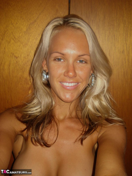 Hot blonde Aussie Jewel displays her large breasts while taking undressed selfies
