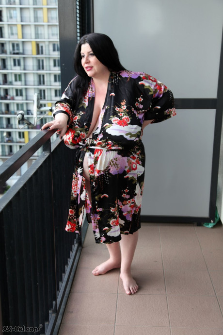 MILF Natalie Fiore disrobes to show her large melons & heavily pregnant tummy