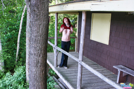 Fine redheaded bitch GF woman teen Satine uncovers her small tits on a rustic porch