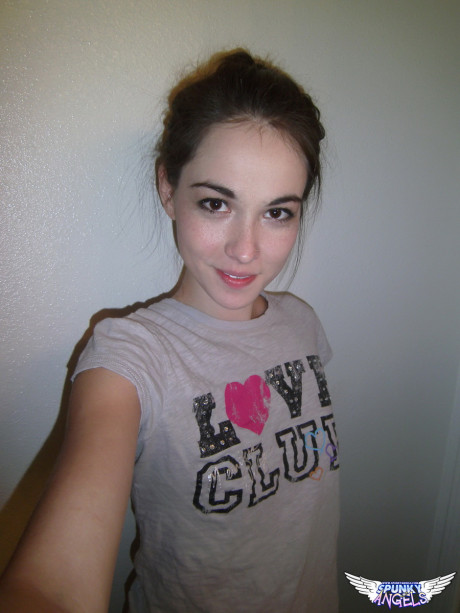Lovely brunette Emily undressing to take self shots of her unprotected tits and hot butt