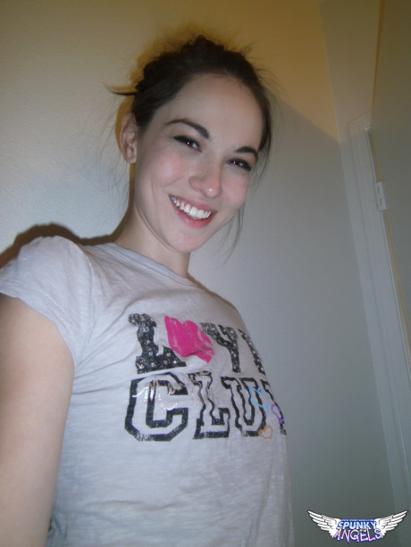Lovely brunette Emily undressing to take self shots of her unprotected tits and hot butt