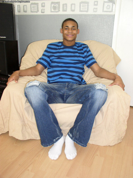 Attractive black gay Andrew smiles while stripping and masturbating in a solo