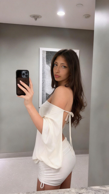 Brunette amateur takes selfie shots in a number of different outfits