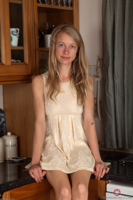 Amateur teenie Selena reveals her silky twat and small breasts in the kitchen