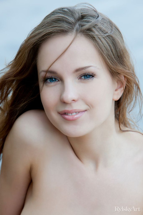 Euro model Ilze wears a smile on stunning fine face during naked posing on dock