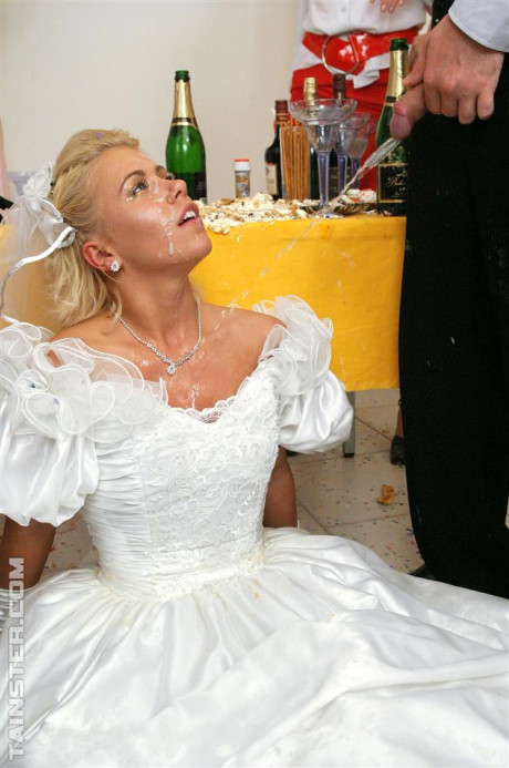 New bride dressed in her wedding dress plays water sport games at reception