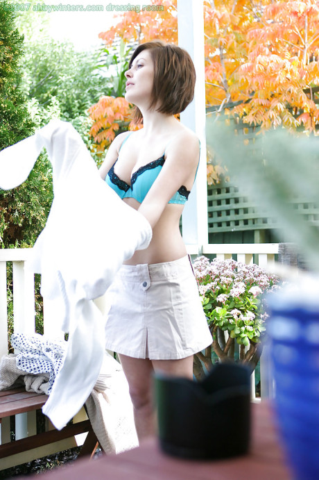 Amateur babe Brandy removing her bra and panties outdoors as seen by voyeur