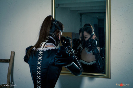 Korean model poses for a solo shoot in a dirty rubber maid outfit