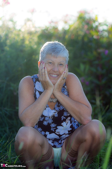 Silver haired granny Savana gets undressed outdoors on a blanket in nylons