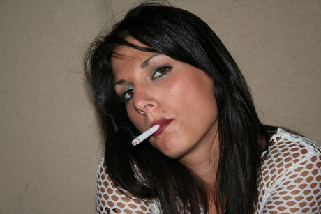 Amateur Korri smokes a cigarette & flaunts her enormous natural melons on a terrace