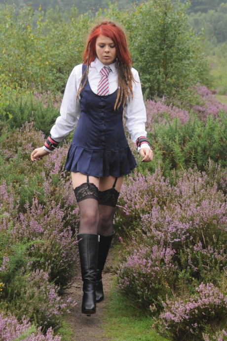 Tall schoolgirl shows off her hot legs in nylons and boots outdoors