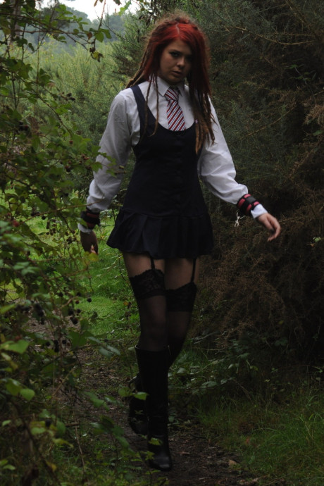Tall schoolgirl shows off her hot legs in nylons and boots outdoors