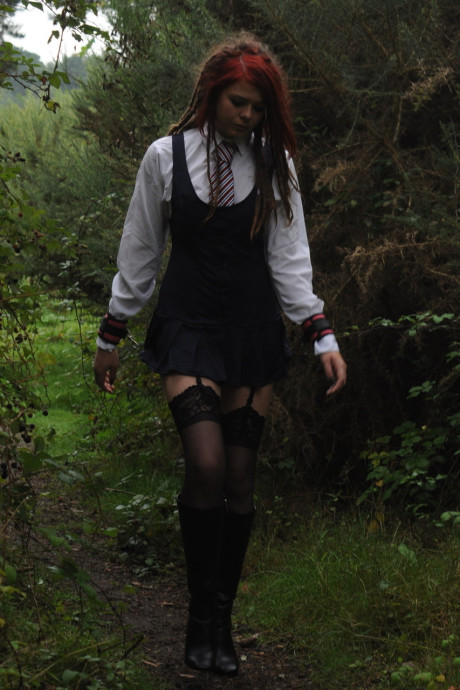 Tall schoolgirl shows off her hot legs in nylons and boots outdoors