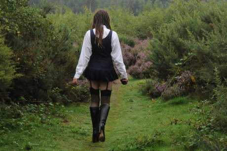 Tall schoolgirl shows off her hot legs in nylons and boots outdoors