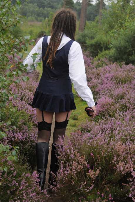 Tall schoolgirl shows off her hot legs in nylons and boots outdoors