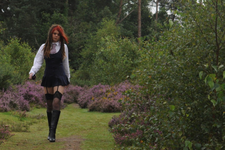 Tall schoolgirl shows off her hot legs in nylons and boots outdoors