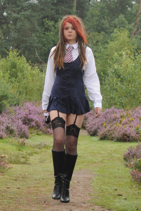 Tall schoolgirl shows off her hot legs in nylons and boots outdoors