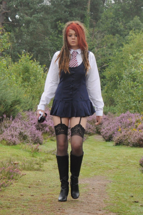 Tall schoolgirl shows off her hot legs in nylons and boots outdoors