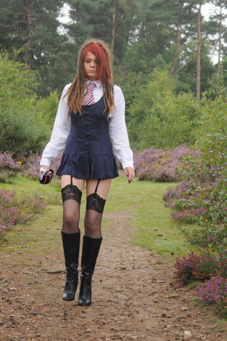 Tall schoolgirl shows off her hot legs in nylons and boots outdoors