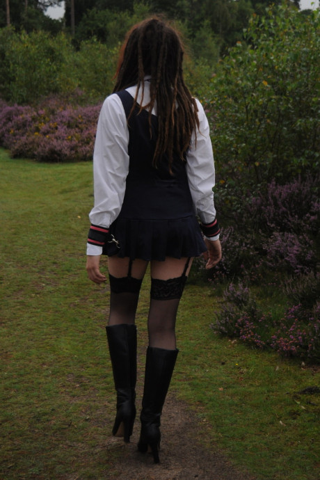 Tall schoolgirl shows off her hot legs in nylons and boots outdoors