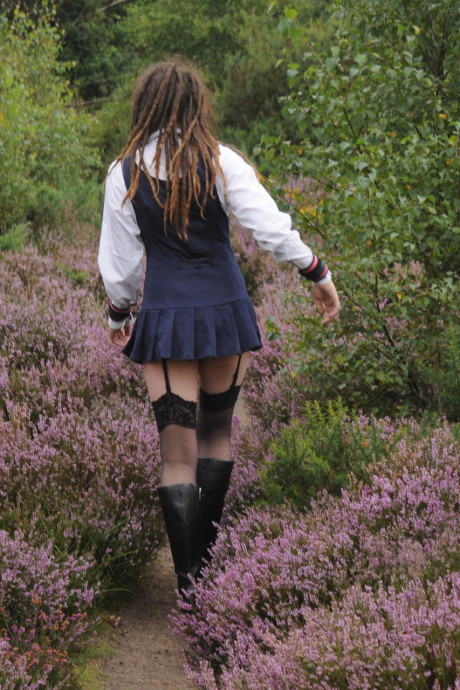 Tall schoolgirl shows off her hot legs in nylons and boots outdoors