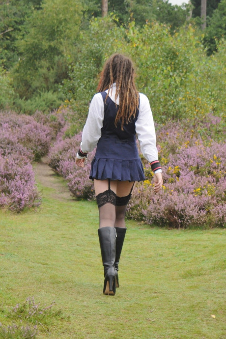Tall schoolgirl shows off her hot legs in nylons and boots outdoors