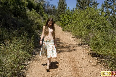 Barely legal skank gf woman with a charming ass gets nude on a road in the woods
