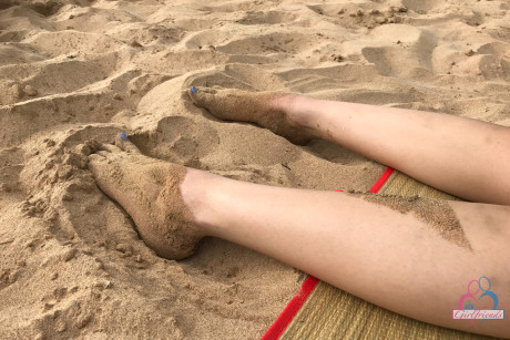 Amateur girl Liza Rowe poses in her pretty bikini on a sandy beach