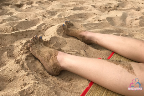 Amateur girl Liza Rowe poses in her pretty bikini on a sandy beach