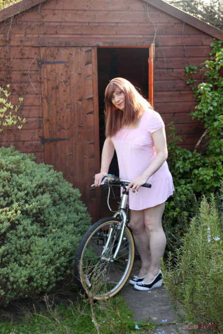 Redheaded trans broad pulls out her cock while riding a bicycle