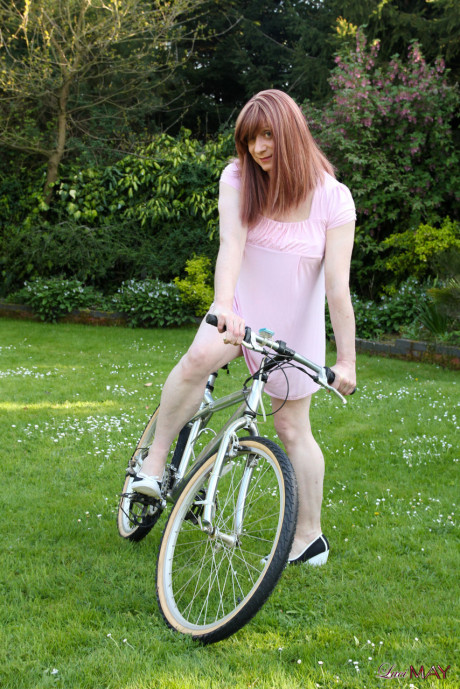 Redheaded trans broad pulls out her cock while riding a bicycle