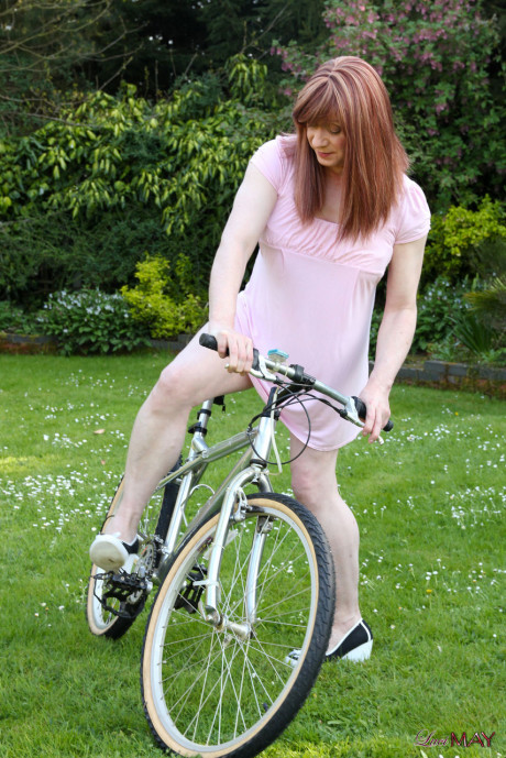 Redheaded trans broad pulls out her cock while riding a bicycle