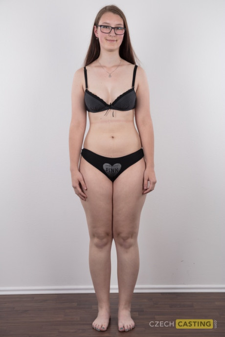 Nerdy young Katerina stands naked as can be other than her glasses in the naked