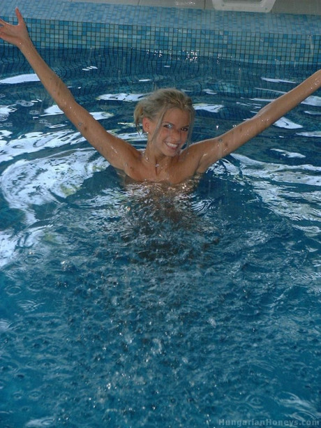 Pretty blondy young Lilu plays nude in the pool before posing with two studs