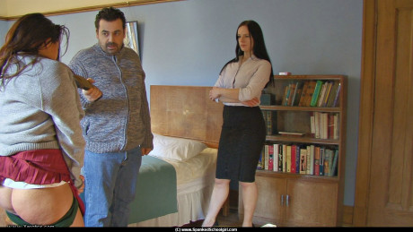 Caucasian student holds her raw behind after being spanked with a slipper