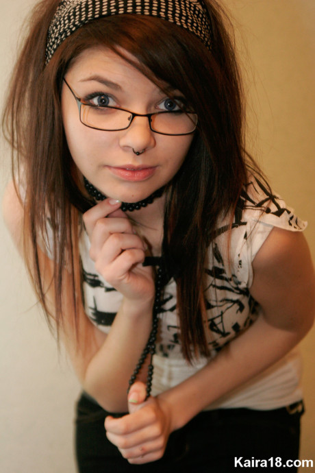 Young young brunette Kaira 18 takes off her glasses while modelling non undressed