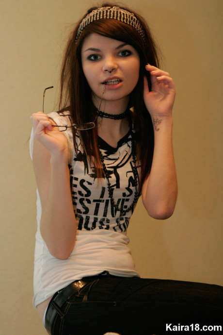 Young young brunette Kaira 18 takes off her glasses while modelling non undressed