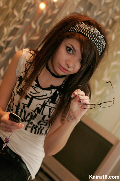 Young young brunette Kaira 18 takes off her glasses while modelling non undressed