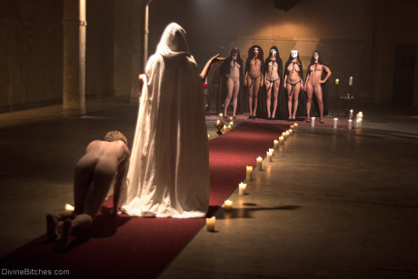 Horny dommes drip hot wax on a bound man back in a secret BDSM sex ritual