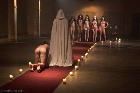 Horny dommes drip hot wax on a bound man back in a secret BDSM sex ritual