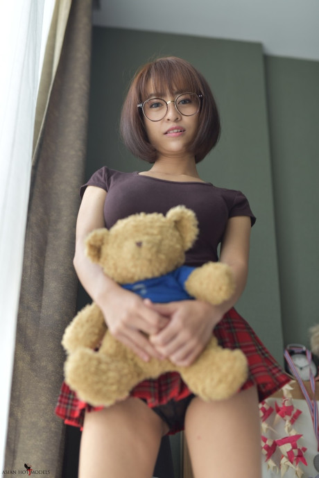 Stunning attractive oriental young flaunts her hot booty wearing a miniskirt and panties