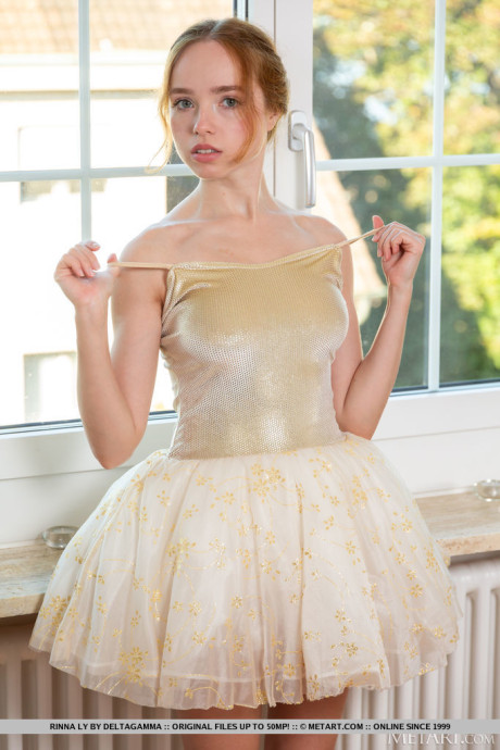 Fresh young ginger head Rinna Ly removes her ballerina clothing while getting naked