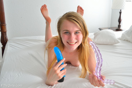 Tiny titted masturbating young Sharlotte drives a dildo deep into her tight booty