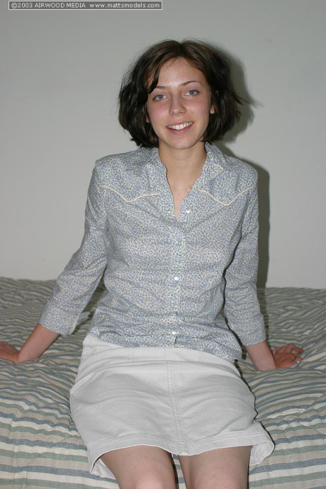 Brunette amateur Nico finger spreads her trimmed snatch after disrobing on bed